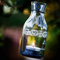 glass bottle with tea light candle