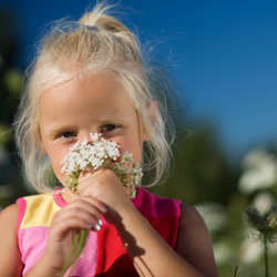 Young child posing with flower